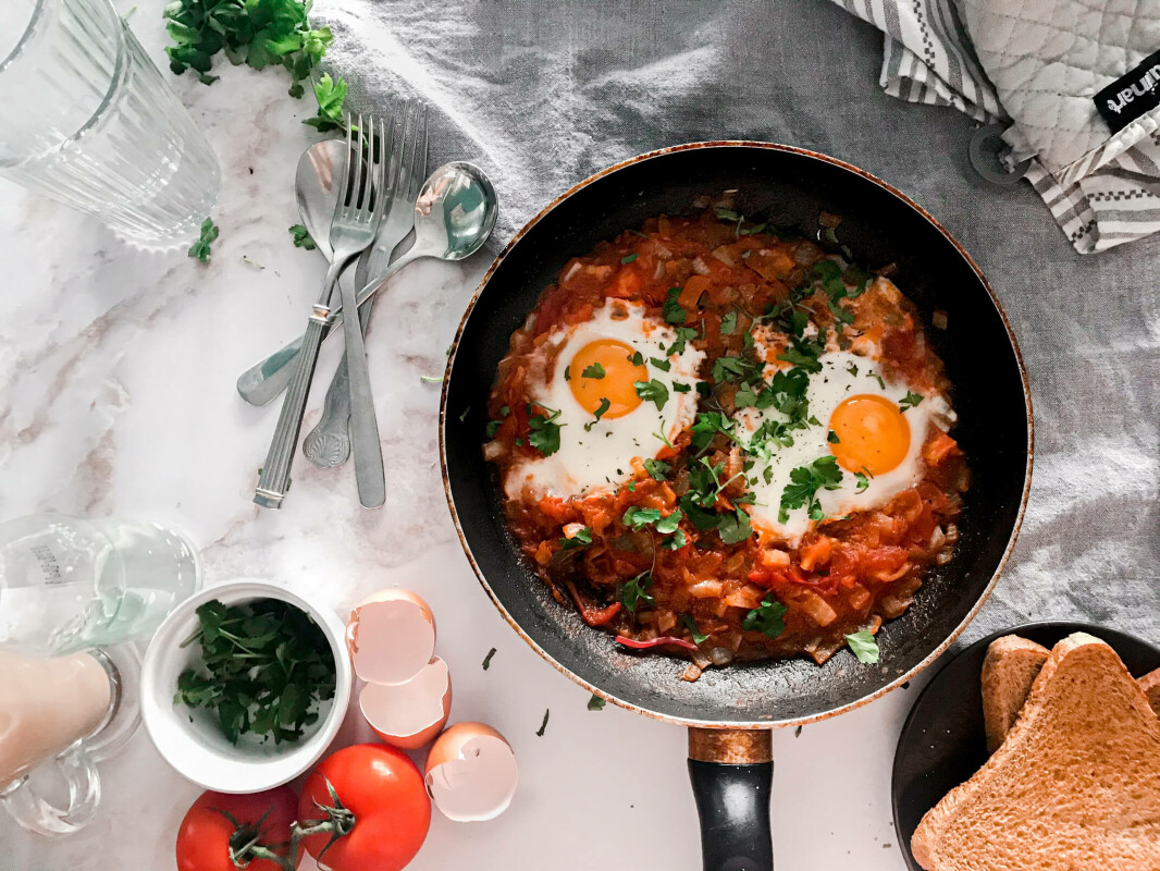 Shakshuka eggs in pan on table. Shakshuka is a common ramadan suhoor meal